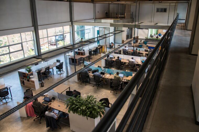 An open plan office floor seen from a walkway above