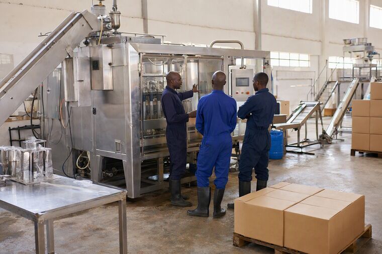 A supervisor with two operators at a machine